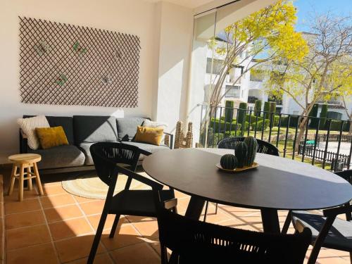 a living room with a table and chairs and a couch at El Cacto in Murcia