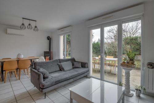 un salon avec un canapé et une table dans l'établissement Maison Rimbaud, à Saint-Denis-lès-Bourg