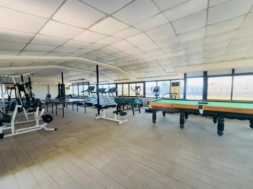 a large room with a pool table and other equipment at Nilkanth Resort - Best Resort in Anand in Anand