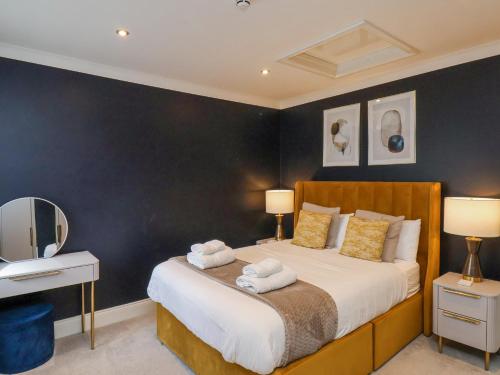a bedroom with a bed with two lamps and a mirror at The Salisbury 1 Bed Classic Apartment in Scarborough