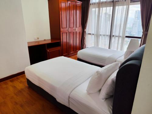 Postel nebo postele na pokoji v ubytování Citypluse Suites at Times Square Kuala Lumpur