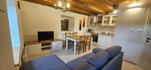a living room with a couch and a table and a kitchen at Country house Viskic in Supetarska Draga