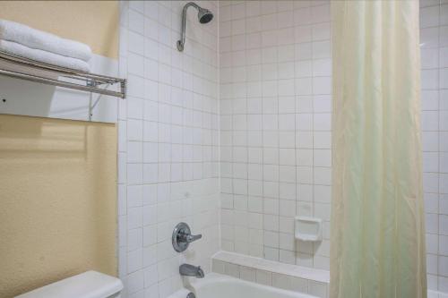 a bathroom with a shower with a toilet and a sink at Super 8 by Wyndham San Marcos in San Marcos