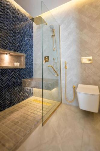 a bathroom with a shower and a toilet at Kyona Marina in Jeddah