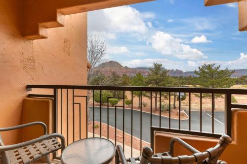 a balcony with chairs and a view of a road at Hilton Vacation Club Sedona Summit in Sedona