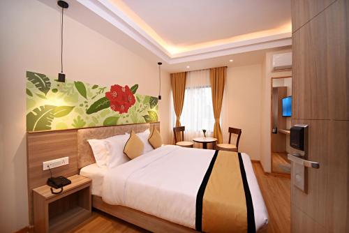 a hotel room with a bed and a tv at Temple Suites Kathmandu in Kathmandu