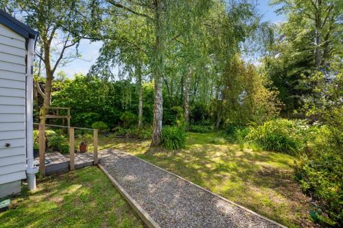 a backyard with a fence and trees and grass at The Majestic Vista in Blenheim