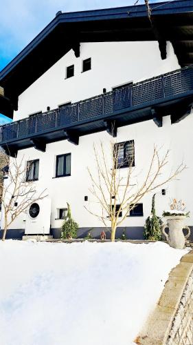 a building with snow in front of it at Ferienwohnung Kapar in Pfarrwerfen