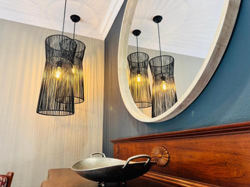 a bathroom with a mirror and a bowl and chandelier at 34 Saligna st - 6 Guests Self Catering in Polokwane