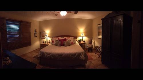a bedroom with a bed and a table with a chair at A Dream Condo With Private Pool At 7 Seas Beach in Fajardo