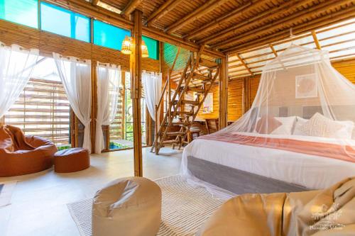a bedroom with a bed and a chair in a room at Vimala Bamboo #1, Villa with Private Jacuzzi Pool in Hua Hin