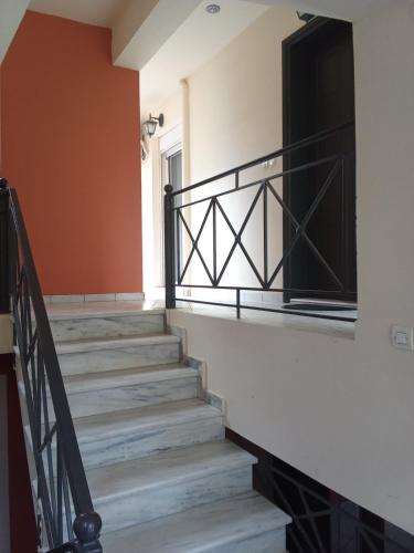 a staircase in a house with a black railing at Seaside Astros Getaway - La Maison Etoile in Paralion astros