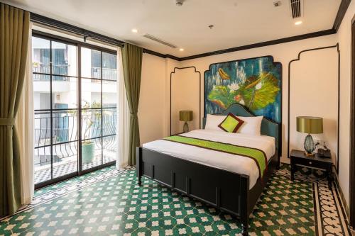 a bedroom with a bed and a large window at Charmpearl Hotel & Suites in Hanoi
