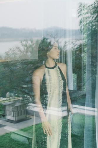 a woman standing in front of a window at FU VALLEY Hotel in Liyang