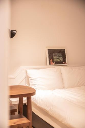 a room with a white bed and a table at Stay A Hotel Gwangan in Busan