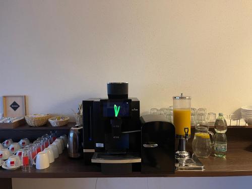 a coffee maker with a green x on it on a counter at River View Apartments Hotel in Bratislava