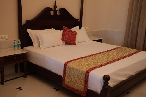 a bedroom with a large bed with two pillows at Jawai Bera Leopard Camp in Bera