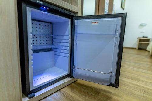 a refrigerator with its door open in a room at Hotel Cristallo in Riolo Terme