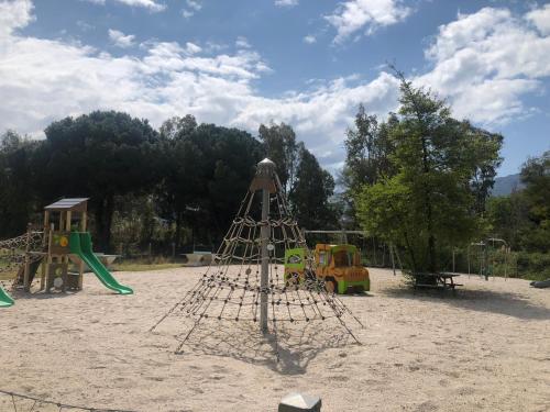 a playground with a swing set and a slide at Camping Dolce Vita in Calvi