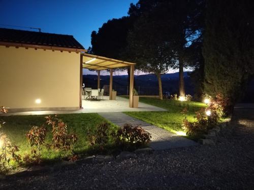 a garden with a pavilion at night at Agriturismo Poggio Rotondo in San Gimignano