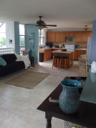 a kitchen and living room with a couch and a table at Beautiful Home At The Hill With Private Pool in Ceiba