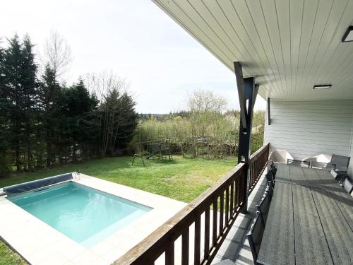 a swimming pool on a porch of a house at Le Bercail in Somme-Leuze