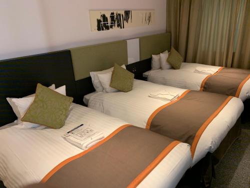 Postel nebo postele na pokoji v ubytování Hotel Vista Hiroshima