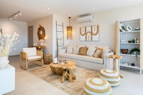 a living room with a couch and a table at Aelia - Chic 2-BR Apartment & Balcony in Larnaca in Larnaca