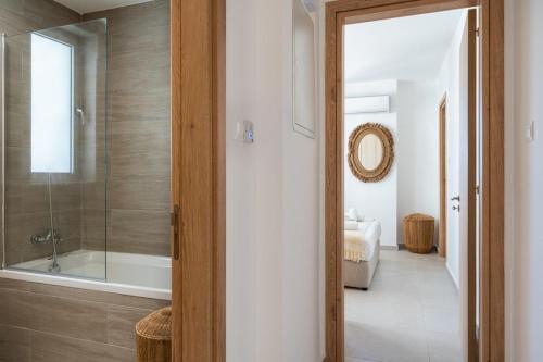 a bathroom with a shower and a tub and a sink at Aelia - Chic 2-BR Apartment & Balcony in Larnaca in Larnaca