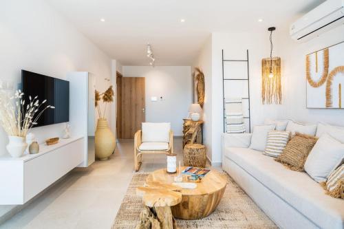 a living room with a white couch and a table at Aelia - Chic 2-BR Apartment & Balcony in Larnaca in Larnaca