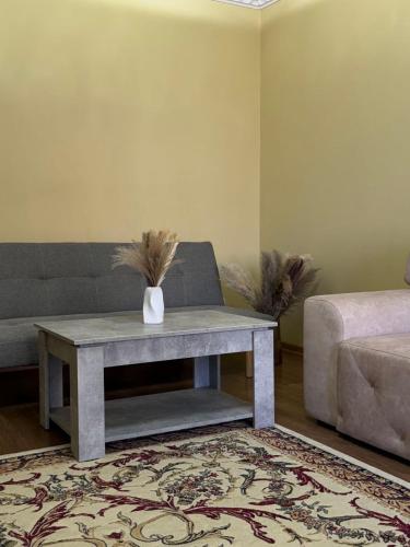 a living room with a couch and a table at 2-к квартира в ЖК Андріївський Центр in Ternopilʼ