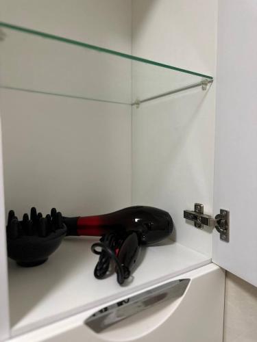 a bathroom counter with a black and red object next to a sink at 2-к квартира в ЖК Андріївський Центр in Ternopilʼ