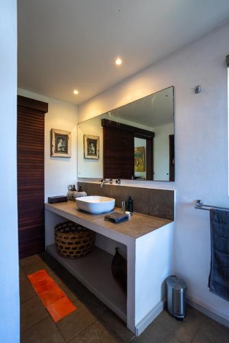 a bathroom with a sink and a mirror at Luxury Villa in le Morne in Le Morne