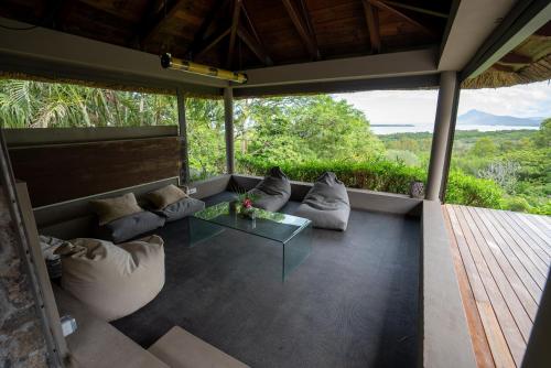 a living room with a couch and a glass table at Luxury Villa in le Morne in Le Morne
