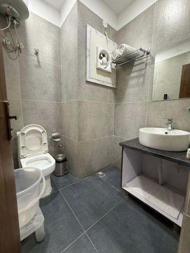 a bathroom with a toilet and a sink at Hotel 7 Heaven in Dehradun