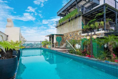 河内Charmpearl Hotel & Suites的建筑物前的游泳池
