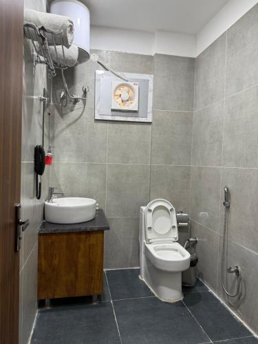 a bathroom with a toilet and a sink at Hotel 7 Heaven in Dehradun