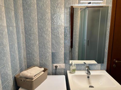 a bathroom with a sink and a mirror at Val Taleggio 4 posti con Camino Check in 24h WiFi in Peghera