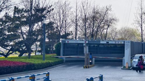 a parking lot with a gate in a park at 青岛海天大酒店 山海相拥典雅奢华 in Qingdao