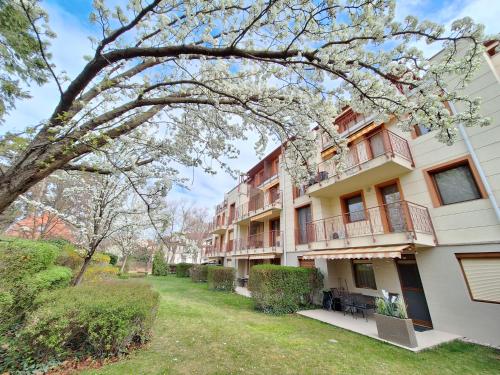 an apartment building with a yard in front of it at Sunny Apartman in Siófok