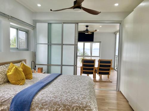 a bedroom with a bed and a ceiling fan at Villa Miyoko Ko Yao Noi Enjoy nature's beauty and stunning sunsets in Ko Yao Noi