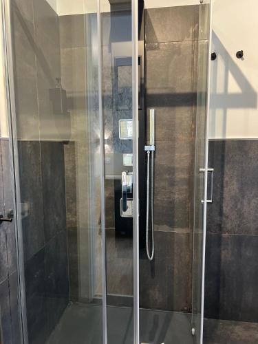 a shower with a glass door in a bathroom at Asso Residence Gold in Terni