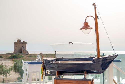 a boat on a table with a street light at da Rocco B&B in Sant'Isidoro