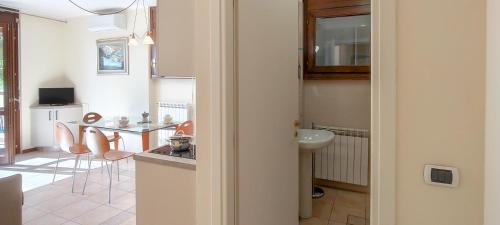 a kitchen with a sink and a table with chairs at Verde Acqua in Stresa