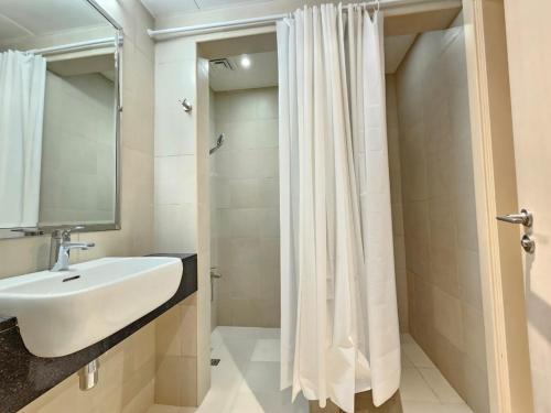 a bathroom with a sink and a shower curtain at KCA c5- 608 in Abu Dhabi