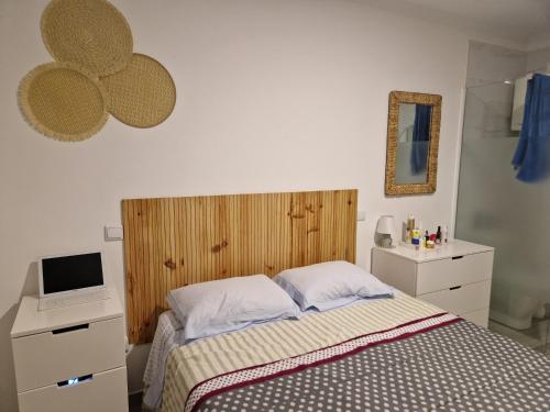 a bedroom with a bed and a desk with a laptop at Estrela de Aver o Mar in Póvoa de Varzim