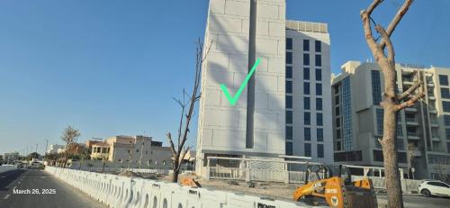 a building with a green arrow on the side of it at KCA c5- 608 in Abu Dhabi