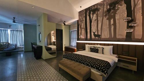 a bedroom with a bed and a large painting on the wall at Srina Vilas, Corbett in Rāmnagar