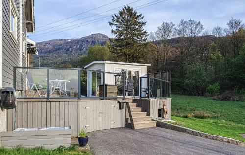 a small house with a deck with a glass door at 5 Bedroom Lovely Home In Bjoa in Utbjoa