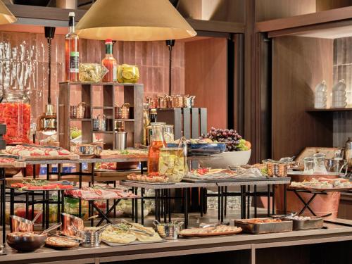 a buffet with many different types of food on display at Mövenpick Resort & Spa Karpacz in Karpacz